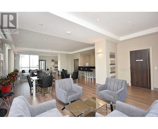 A living room with grey couches and a glass coffee table.