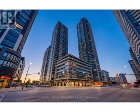 A city street with tall buildings and a sign that reads "Royal LePage Signature Realty, Brokerage".