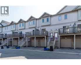 A row of townhouses with garages in front.