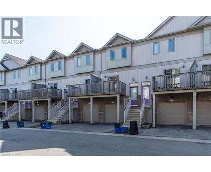 A row of townhouses with garages in front.