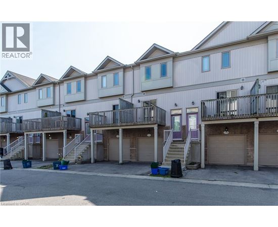 A row of townhouses with garages in front.