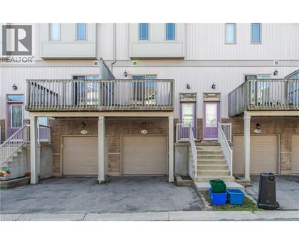 A building with a balcony and a garage door.