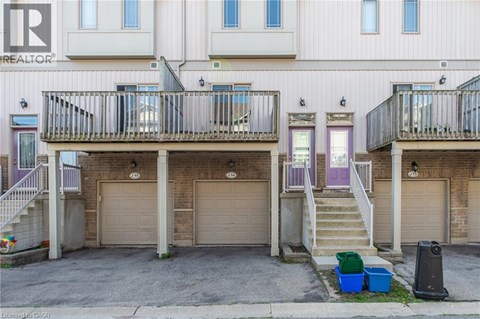 A building with a balcony and a garage door.