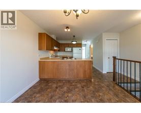 A realtor's office with a wooden counter and a staircase.