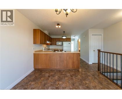 A realtor's office with a wooden counter and a staircase.