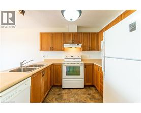 A kitchen with wooden cabinets and a white stove top oven.