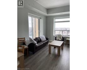 A living room with a couch, chair, and table.