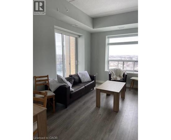 A living room with a couch, chair, and table.