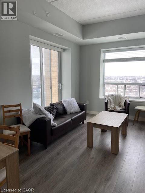 A living room with a couch, chair, and table.