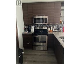 A modern kitchen with a stainless steel oven and microwave.