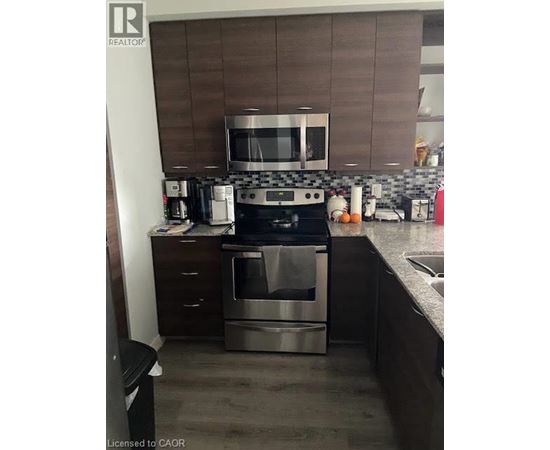 A modern kitchen with a stainless steel oven and microwave.