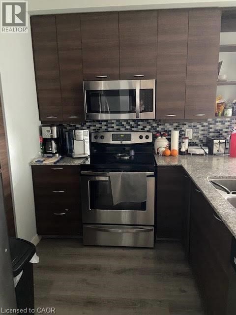 A modern kitchen with a stainless steel oven and microwave.