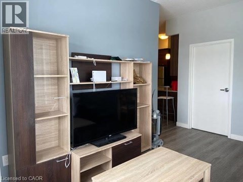 A living room with a television and a wooden cabinet.