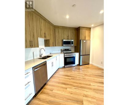 A kitchen with wooden cabinets and stainless steel appliances.