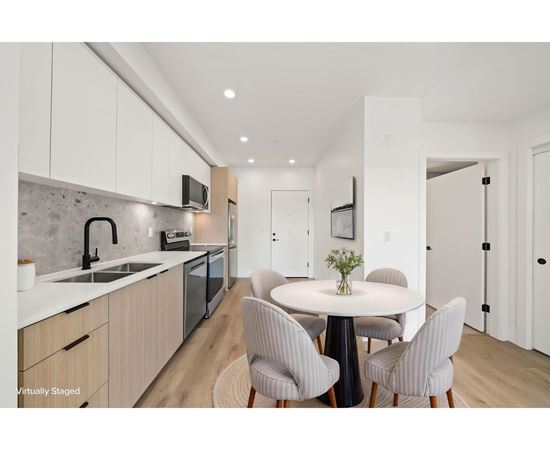 A modern kitchen with a dining table set for four.