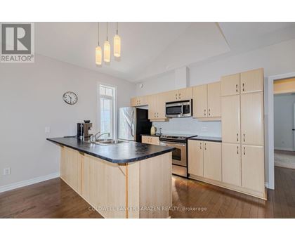 A kitchen with wooden cabinets and a black countertop.