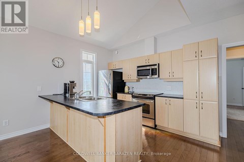 A kitchen with wooden cabinets and a black countertop.