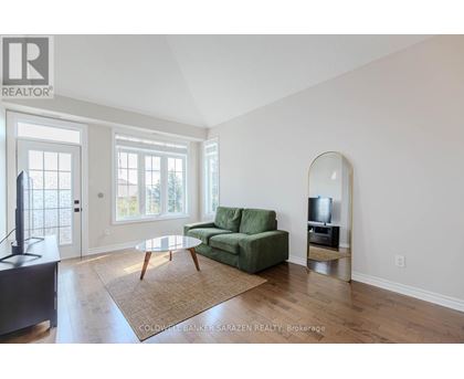 A living room with a green couch and a television.