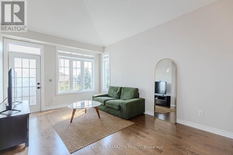 A living room with a green couch and a television.