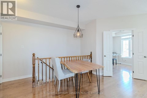 A dining room with a wooden table and chairs.