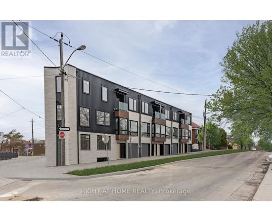 A street view of a building with the sign "RIGHT AT HOME REALTY, Brokerage" on it.