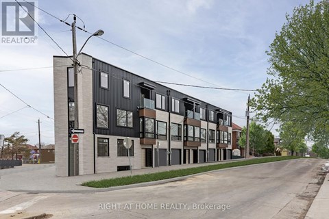 A street view of a building with the sign "RIGHT AT HOME REALTY, Brokerage" on it.