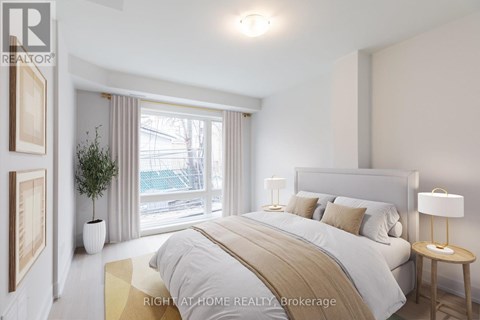 A bedroom with a large bed and a view of a balcony through the window.