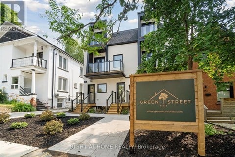 A sign for Green Street in front of apartment buildings.