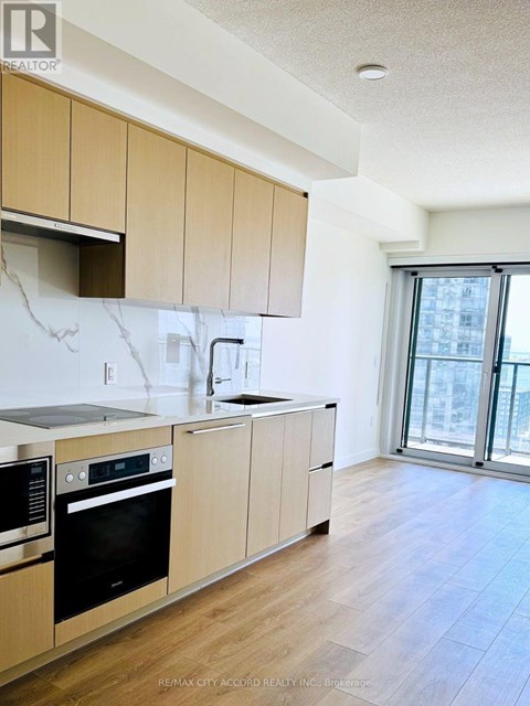 A kitchen with wooden cabinets and black appliances.