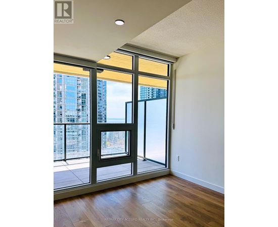 A room with a sliding glass door leading to a balcony.