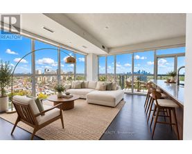 A living room with a view of the city skyline.