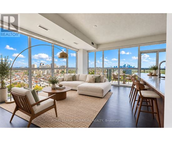 A living room with a view of the city skyline.