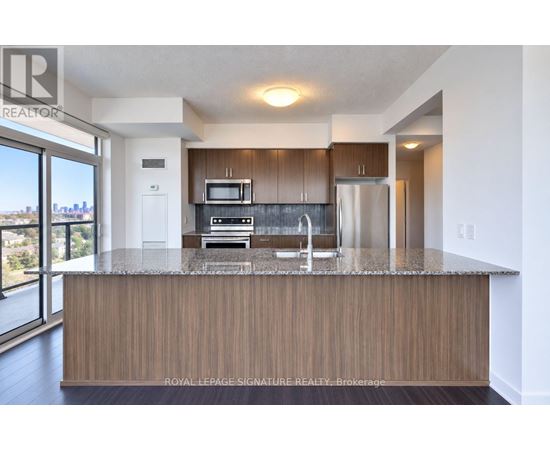 A modern kitchen with wooden cabinets and stainless steel appliances.