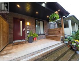 A house with a red door and a wooden porch.