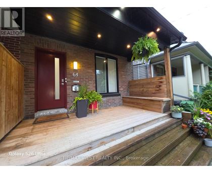 A house with a red door and a wooden porch.