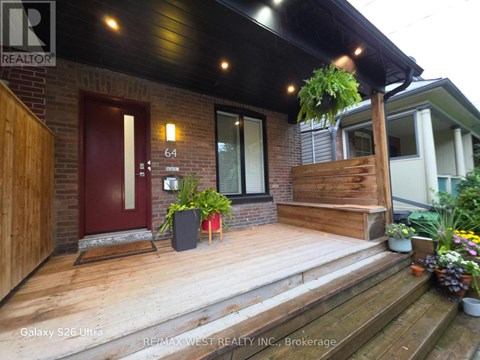 A house with a red door and a wooden porch.