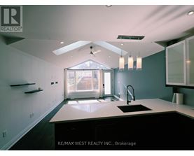 A kitchen with a sink and a window.
