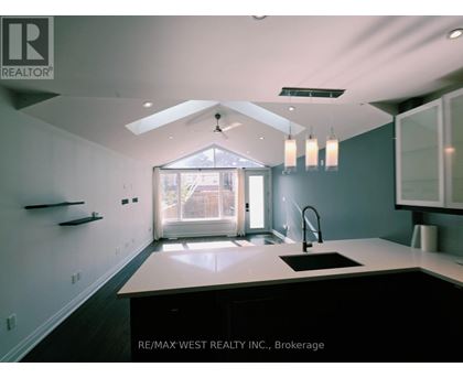 A kitchen with a sink and a window.