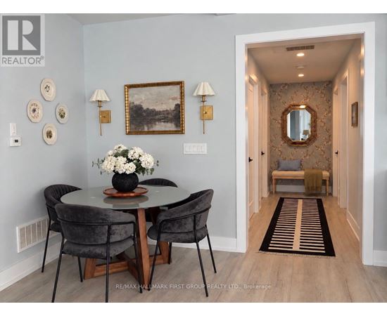 A dining room with a round table and chairs.