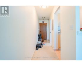 A hallway with a pair of shoes on the floor.