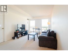 A living room with a couch, a coffee table, and a television.