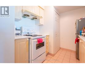 A kitchen with a white oven and a white fridge.