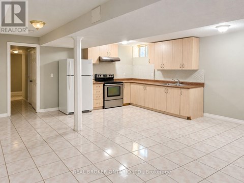 A kitchen with white appliances and wooden cabinets.