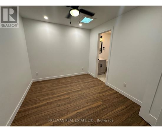 A room with wooden flooring and a ceiling fan.