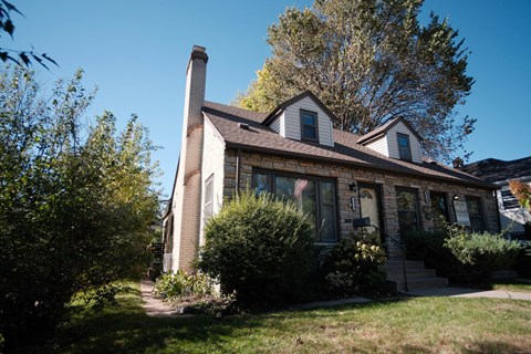 A house with a brown roof and a white door.