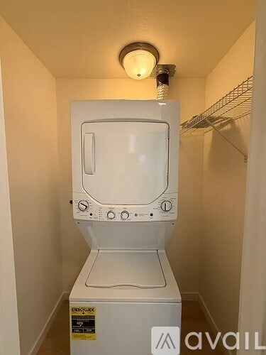 A white washing machine in a small laundry room.