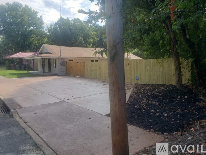 A house with a brown roof and a yellow fence.