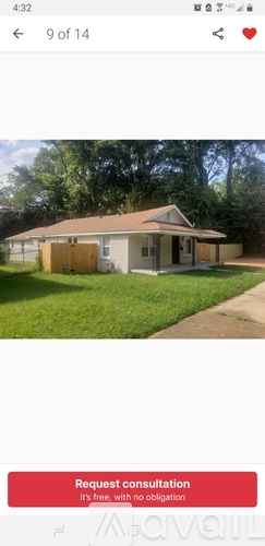 A house with a brown roof and a white wall is shown.