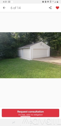 A white garage is shown in a grassy area with a red button that says "Request consultation".