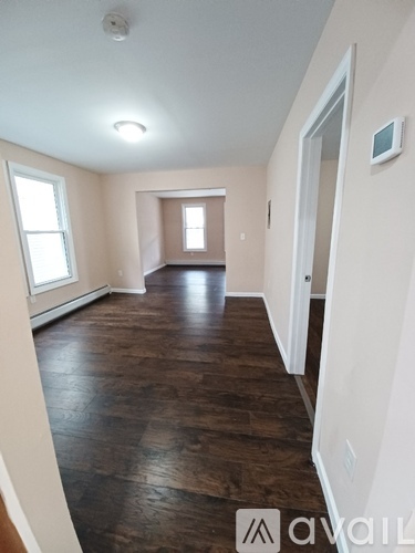 A room with wooden floors and white walls.